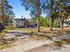 Charming single-story home featuring a neatly landscaped front yard and a welcoming pink door at 6202 Tennessee Ave, New Port Richey, FL 34653