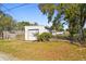 View of the detached garage with a garage door and partially fenced in backyard at 6202 Tennessee Ave, New Port Richey, FL 34653