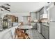Bright kitchen featuring grey cabinets, an adjacent dining area, and stylish decor at 6202 Tennessee Ave, New Port Richey, FL 34653