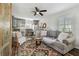 Comfortable living space with a gray sofa, wooden floors, and a stylish rug at 6202 Tennessee Ave, New Port Richey, FL 34653