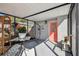 Covered patio with hanging chair, decorative plants, and bright lighting at 6202 Tennessee Ave, New Port Richey, FL 34653