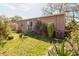 View of the backyard showing the back of the house with tropical plants at 6585 86Th N Ave, Pinellas Park, FL 33782