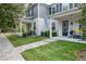 Charming townhome with a covered front porch and manicured lawn at 6615 S Manhattan Ave # 2, Tampa, FL 33616