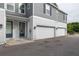 Gray townhouse exterior with garages and adjacent front door entrances at 6615 S Manhattan Ave # 2, Tampa, FL 33616