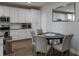 Bright kitchen featuring white cabinets, modern appliances, and countertop dining at 6615 S Manhattan Ave # 2, Tampa, FL 33616