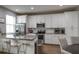 Modern kitchen featuring stainless steel appliances, white cabinets, and island seating at 6615 S Manhattan Ave # 2, Tampa, FL 33616