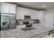 Modern kitchen features stainless steel appliances, granite countertops, and white cabinetry at 6615 S Manhattan Ave # 2, Tampa, FL 33616