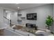 Comfortable living room with a gray sofa, TV, and wall decor at 6615 S Manhattan Ave # 2, Tampa, FL 33616