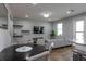 Open-concept living space with dining area, modern decor, and hardwood flooring at 6615 S Manhattan Ave # 2, Tampa, FL 33616