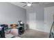 This home office features multiple monitors, a glass desk and is brightly illuminated with natural light at 6615 S Manhattan Ave # 2, Tampa, FL 33616