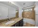 Bathroom featuring granite countertops and a bathtub with tile walls at 6808 S Sparkman St, Tampa, FL 33616