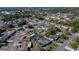 An aerial perspective captures the neighborhood, highlighting mature trees and proximity to local amenities at 7305 Windsor St, Hudson, FL 34667
