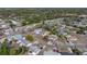 High angle aerial shot showcases the house and neighborhood amidst mature trees providing natural shade at 7305 Windsor St, Hudson, FL 34667