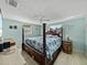 Bedroom with an antique four post bed and decorative barrel table at 7305 Windsor St, Hudson, FL 34667