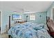 Beautiful primary bedroom showcasing a large bed, television, and light blue walls at 7305 Windsor St, Hudson, FL 34667