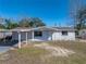 Charming single-story home featuring a carport, front yard, and freshly painted exterior at 7305 Windsor St, Hudson, FL 34667