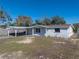 Charming single-story home featuring a carport, front yard, and freshly painted exterior at 7305 Windsor St, Hudson, FL 34667