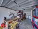 Garage featuring storage, work bench, tools, and laundry machines at 7305 Windsor St, Hudson, FL 34667