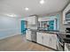 Bright kitchen with white cabinets, stainless steel appliances, and bar seating at 7305 Windsor St, Hudson, FL 34667