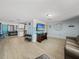 A cozy open living room featuring light wood flooring and an entertainment area at 7305 Windsor St, Hudson, FL 34667
