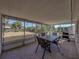 Covered patio showing a table, four chairs, and a grill at 7305 Windsor St, Hudson, FL 34667