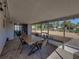 The covered patio features a table with chairs and an overhead light fixture at 7305 Windsor St, Hudson, FL 34667
