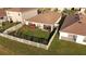 Aerial view of the property showcasing a fenced backyard, patio, and lush green lawn at 7771 Davie Ray Dr, Zephyrhills, FL 33540
