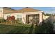 View of the backyard with well-manicured lawn and a covered patio, and garden at 7771 Davie Ray Dr, Zephyrhills, FL 33540