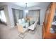 A dining room with a glass table, upholstered chairs and carpet at 7771 Davie Ray Dr, Zephyrhills, FL 33540