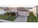 Charming one-story home with well-maintained lawn, landscaping, and attached two-car garage at 7771 Davie Ray Dr, Zephyrhills, FL 33540