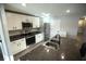 A spacious kitchen with stainless steel appliances, granite countertops, and white cabinets at 7771 Davie Ray Dr, Zephyrhills, FL 33540