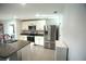 Kitchen featuring stainless steel refrigerator and appliances, with tiled flooring at 7771 Davie Ray Dr, Zephyrhills, FL 33540