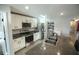 A spacious kitchen with stainless steel appliances, granite countertops, and white cabinets at 7771 Davie Ray Dr, Zephyrhills, FL 33540