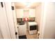 Functional laundry room with a washer, dryer, storage cabinets, and modern lighting at 7771 Davie Ray Dr, Zephyrhills, FL 33540