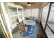 Enclosed patio featuring a ceiling fan and outdoor dining set at 7771 Davie Ray Dr, Zephyrhills, FL 33540