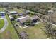 Expansive aerial view showcasing the property, outbuildings, pool, and lush landscaping at 7843 Shoupe Rd, Plant City, FL 33565