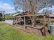 Enclosed outdoor animal pen with mature trees, providing a secure and comfortable space for pets or livestock at 7843 Shoupe Rd, Plant City, FL 33565