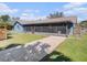A long, screened-in lanai stretches along the rear of the home in this backyard at 7843 Shoupe Rd, Plant City, FL 33565