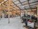 The barn interior has a metal roof, bright lighting, concrete floor, and lots of space for storage or projects at 7843 Shoupe Rd, Plant City, FL 33565