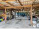 The barn interior has a metal roof, bright lighting, concrete floor, and lots of space for storage or projects at 7843 Shoupe Rd, Plant City, FL 33565