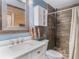 Stylish bathroom with a modern vanity, tiled shower, and tasteful decor for a luxurious experience at 7843 Shoupe Rd, Plant City, FL 33565