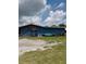 Exterior view of a spacious blue barn, perfect for storage or hobbies at 7843 Shoupe Rd, Plant City, FL 33565