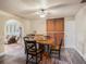 Open dining area with a wooden table set, complemented by hardwood floors and decorative elements at 7843 Shoupe Rd, Plant City, FL 33565