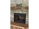 Stone fireplace adorned with a wooden mantle and 'Gathering' centerpiece at 7843 Shoupe Rd, Plant City, FL 33565
