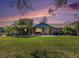 Charming stone home with covered patio, a well-manicured lawn, and a peaceful, inviting atmosphere at 7843 Shoupe Rd, Plant City, FL 33565