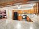 Well-lit kitchen with granite countertops, wooden cabinets, and modern appliances for cooking convenience at 7843 Shoupe Rd, Plant City, FL 33565