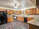 Spacious kitchen equipped with stainless steel appliances, wood cabinets, and granite countertops at 7843 Shoupe Rd, Plant City, FL 33565