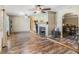 Spacious living room with a stone fireplace and hardwood floors, creating a warm and inviting atmosphere at 7843 Shoupe Rd, Plant City, FL 33565