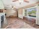 Bright living room with a cozy fireplace and a large bay window showcasing the property's exterior at 7843 Shoupe Rd, Plant City, FL 33565