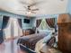 Comfortable main bedroom featuring a ceiling fan, a window, and a private door to the outside at 7843 Shoupe Rd, Plant City, FL 33565